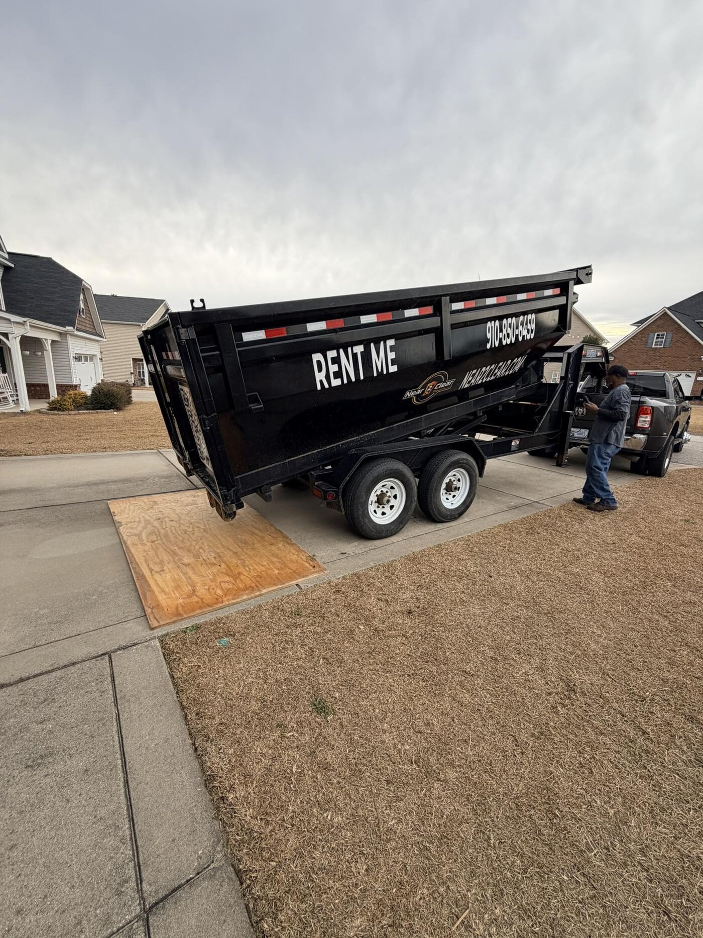 Roll-off dumpster placed carefully on a driveway
